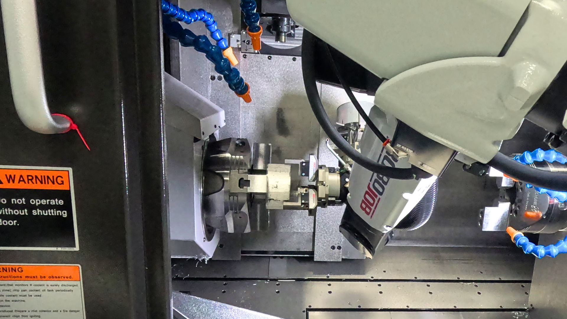 Robojob Turn-Assist Essential Mini Loading Part into a Tsugami TMA8F