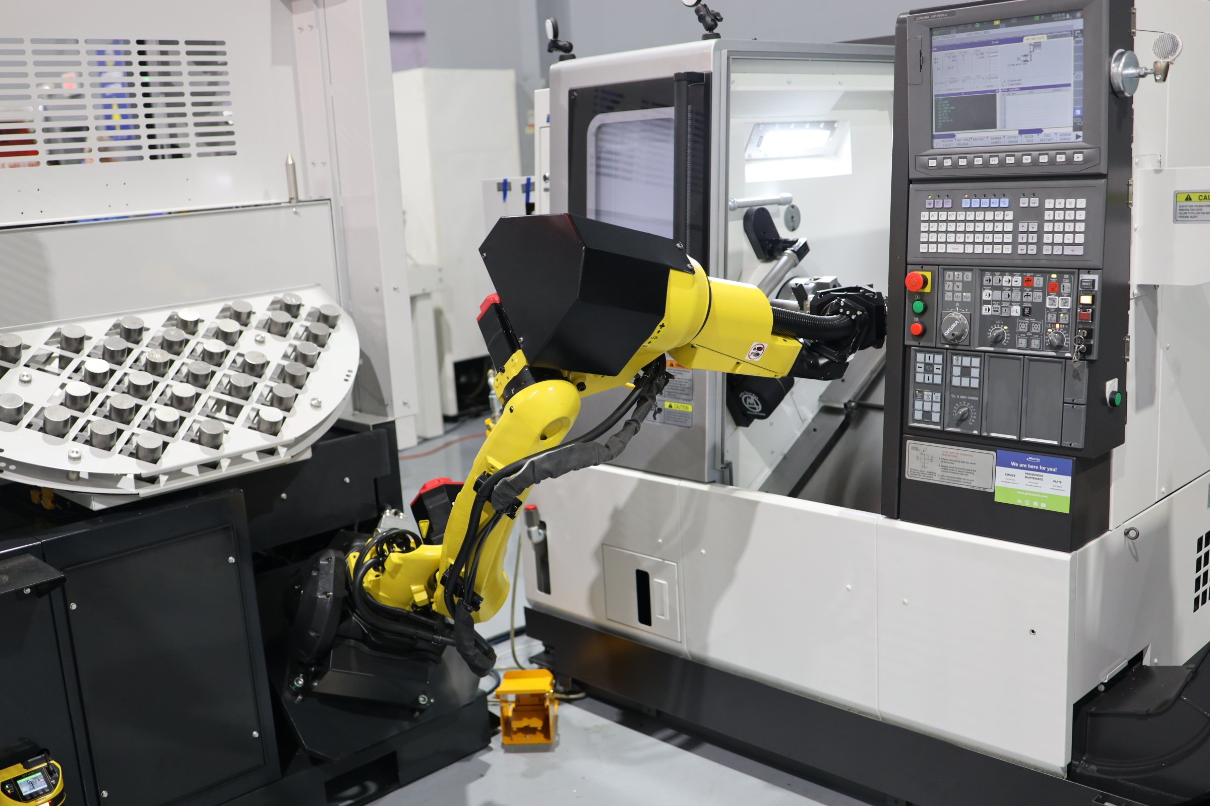 Cobot cart loading a part inside a CNC machine for automated manufacturing processes